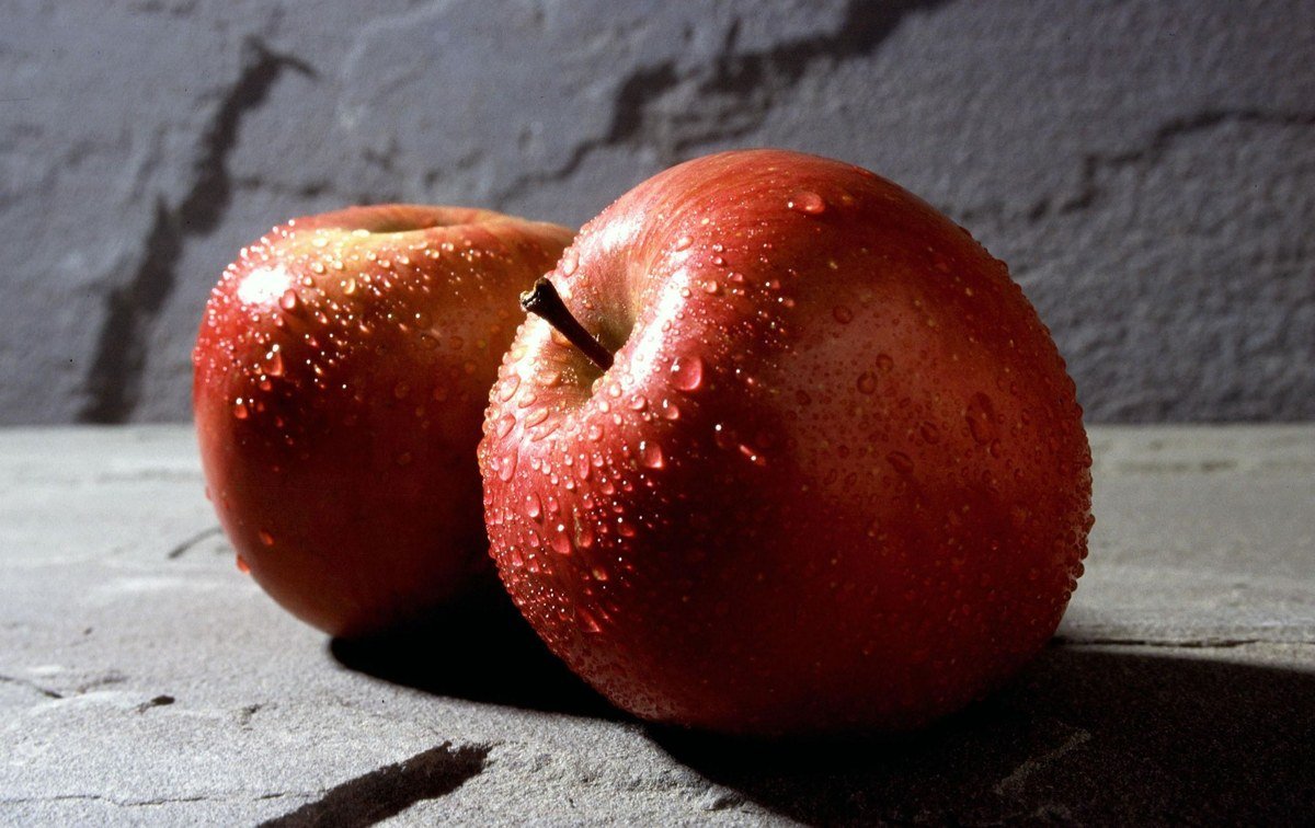 Fresh red and green apples in wooden crates